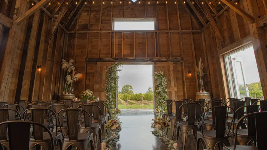 A wedding ceremony in a barn at a vineyard in Niagara, Canada.